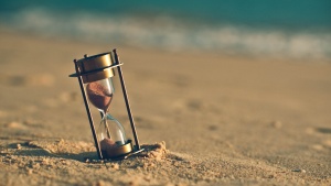 Hourglass On Sand Beach